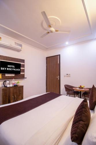 a bedroom with a bed and a ceiling fan at HOTEL S R Palace - Free Airport Drop for Minimum 05 Nights Stay - 5 mins from IGI & Domestic Airport Delhi in New Delhi