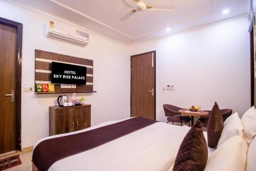 a hotel room with a bed and a desk at HOTEL S R Palace - Free Airport Drop for Minimum 05 Nights Stay - 5 mins from IGI & Domestic Airport Delhi in New Delhi