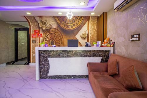 a lobby with a couch and a reception counter at HOTEL S R Palace - Free Airport Drop for Minimum 05 Nights Stay - 5 mins from IGI & Domestic Airport Delhi in New Delhi