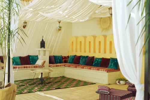 a living room with a couch and a table at Villa Huneric in Sousse