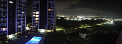 a view of a city at night with buildings at Lenayan at Artesano in Nairobi