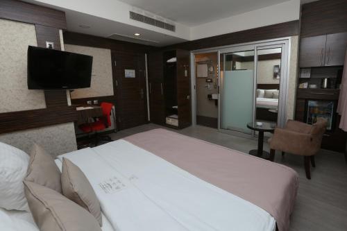 a hotel room with a bed and a television at Wes Hotel in Kocaeli