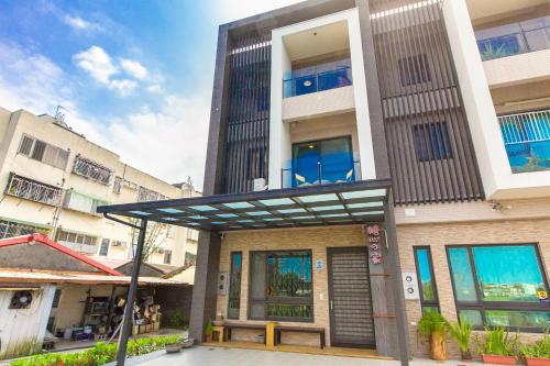 a building with awning in front of it at Candy House in Wujie