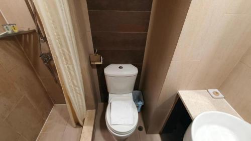 a small bathroom with a toilet and a sink at H1 Hotel in Hong Kong