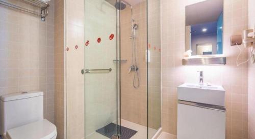 a bathroom with a shower and a toilet and a sink at Jinjiang Inn Select Kunming High-speed South Railway University Town in Kunming
