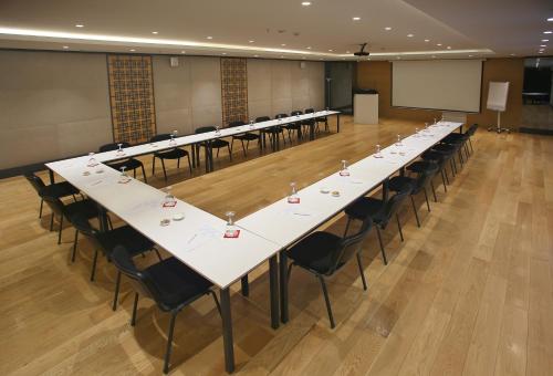 a row of tables and chairs in a large room at Wes Hotel in Kocaeli