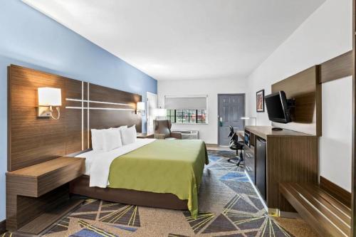 a hotel room with a bed and a television at Quality Inn & Suites Rio Grande City in Rio Grande City