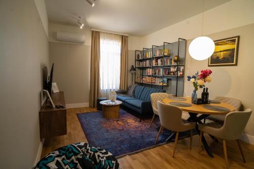 a living room with a blue couch and a table at The Nest in Ruse