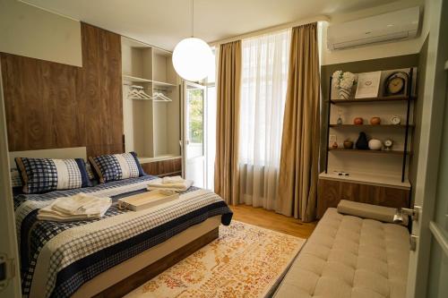 a bedroom with a bed and a large window at The Nest in Ruse