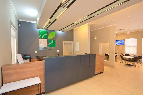 an office lobby with a counter and a dining room at The Park Lodge Hotel in Pretoria