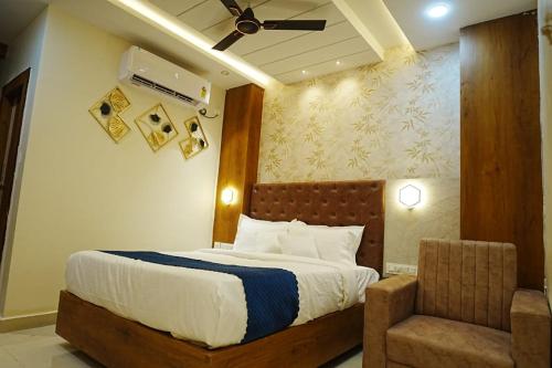 a bedroom with a bed and a chair at HoTEL MOON LIGHT in Vijayawāda