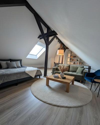 a living room with a couch and a coffee table at Traumwohnung über den Dächern Rüttenscheids in Essen