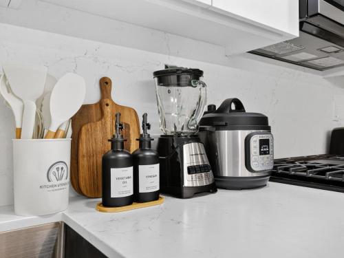 a kitchen counter with bottles and a blender on it at 4BR 3Bath Game Room Harvard MIT Apt in Cambridge