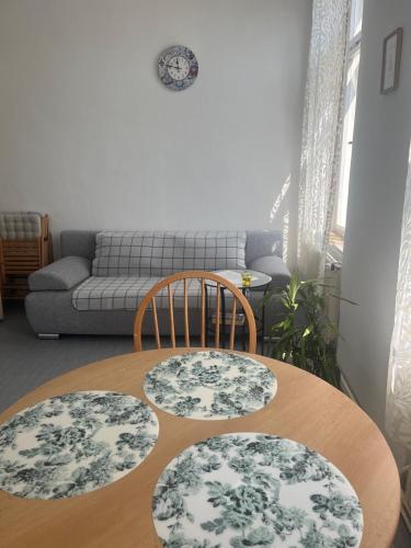 a room with a table and two chairs and a couch at Na Mahlerce in Jihlava