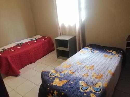 a bedroom with two beds with butterflies on the blanket at The Hope Apartments in Nelspruit