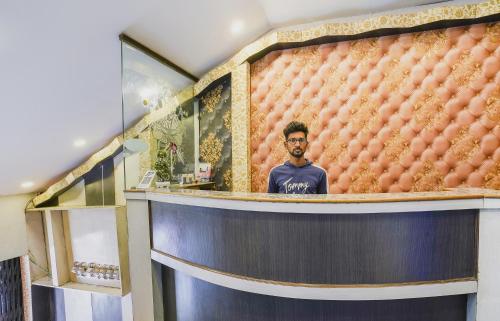 a man standing in front of a wall of balls at SPOT ON Hotel Hyderabad Continental in Hyderabad