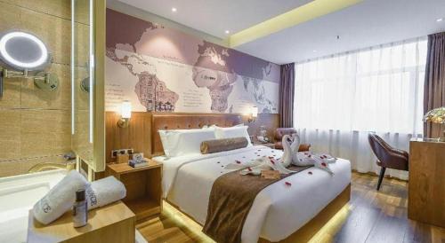 a bedroom with a large bed and a bath tub at James Joyce Coffetel Shenyang North Railway Station Qishan Road Metro Station in Shenyang