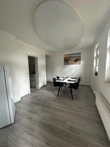 a dining room with a table and chairs at Hotel Luther Birke Wittenberg in Lutherstadt Wittenberg