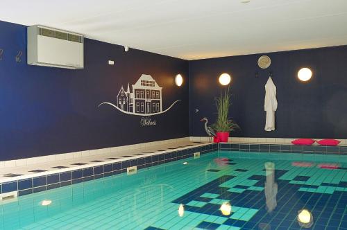 a large swimming pool in a room at Boetiek Hotel BonAparte Lochem in Barchem