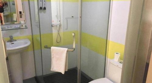 a bathroom with a shower and a toilet and a sink at 7 Days Inn Yiyang Shengli Road in Shangrao