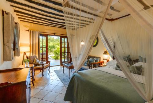 a bedroom with a bed and a living room at Breezes Beach Club and Spa in Bwejuu