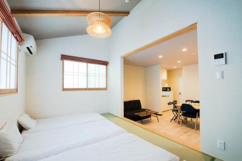 a bedroom with a bed and a living room at Sakuragawa-an Higashiyama in Kyoto