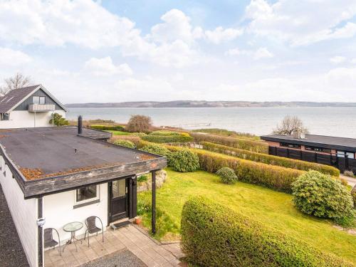 an image of a house with a view of the water at 6 person holiday home in Børkop-By Traum in Børkop