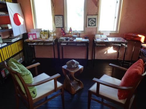 a living room with two chairs and a table at Twin Dome Ryugu in Hokuto