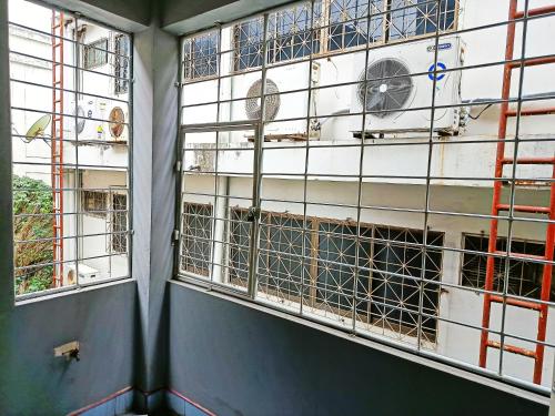 an empty room with two windows and a building at Apartment near Central Festival Hatyai in Hat Yai