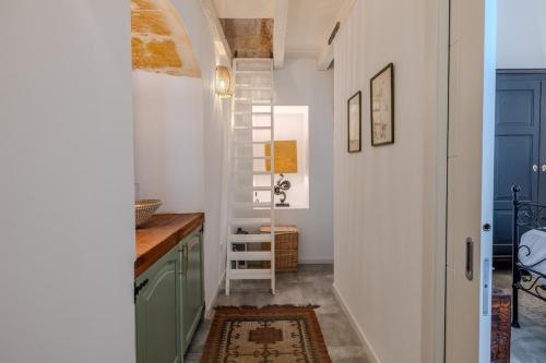 a hallway with a stairway leading to a kitchen at Gharghur Botanic Boutique in Għargħur