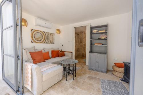a living room with a couch and a table at Gharghur Botanic Boutique in Għargħur