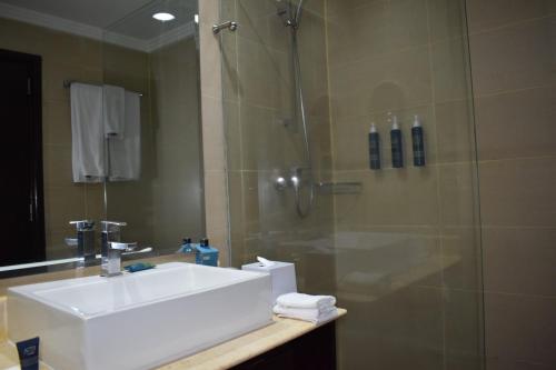 a bathroom with a sink and a shower at Four Points By Sheraton Nairobi Hurlingham in Nairobi
