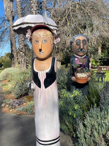 two statues of a woman with an umbrella and a man at Daisy House - Whittington - 10 minutes to central Geelong in Whittington