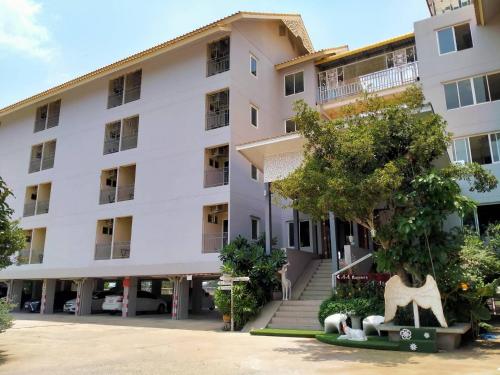 a white building with two animals in front of it at AA Resort Hotel นนทบุรี in Ban Pratu Nam Phra Udom