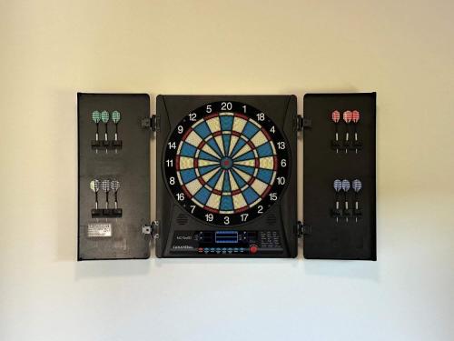 a dart board with four darts on a wall at 10 person holiday home in Vinderup-By Traum in Vinderup