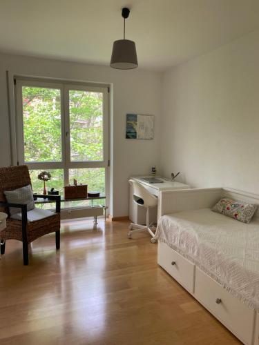 a bedroom with a bed and a desk and a sink at Helle Wohnung am Waldpark in Dresden
