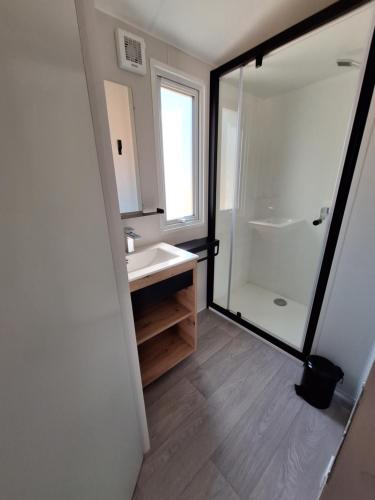 a bathroom with a sink and a shower at Camping des Papillons in Lalizolle