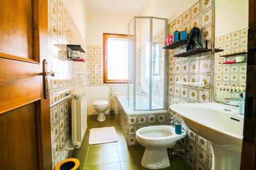 a bathroom with a toilet and a sink at Casa Pini - Near the Lake in Auronzo di Cadore
