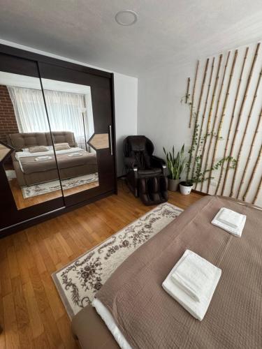 a bedroom with a bed and a large window at Central main street apartament in Vişeu de Sus