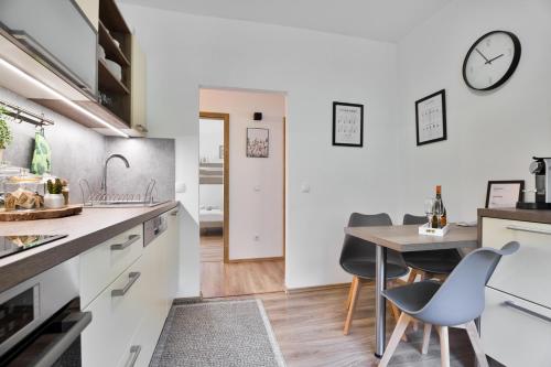 a kitchen and dining room with a table and chairs at Apartmány Hřensko in Hřensko