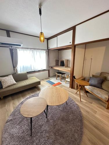 a living room with a table and a couch at Minato House 101 in Fukuoka