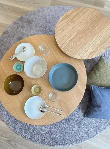 a wooden table with plates and bowls and spoons at Minato House 101 in Fukuoka