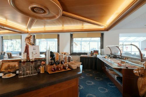 a bar in a restaurant with a counter top at Hotel Cristallo in Santa Cristina in Val Gardena