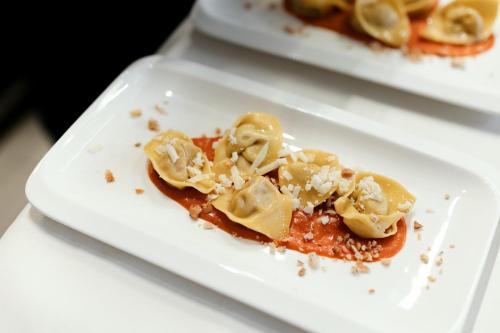 two plates of food on a white plate at Hotel Cristallo in Santa Cristina in Val Gardena