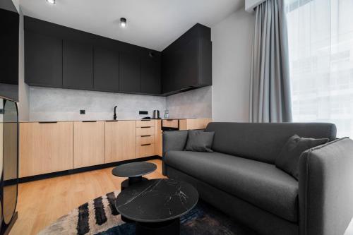 a living room with a couch and a table at Wings Plaza in Kraków