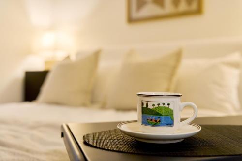 a coffee cup sitting on top of a table with a bed at Soyo Stay SEOUL, Free car driving service to Korean Folk Village, Everland in Seoul
