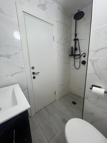a bathroom with a shower and a toilet and a sink at Hadas in the desert in Yeroẖam