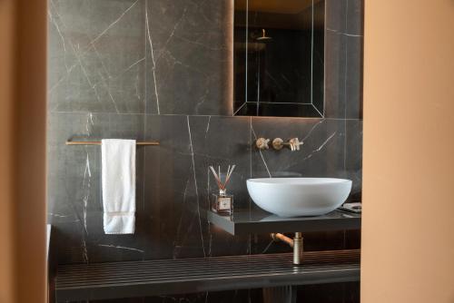 a bathroom with a sink and a mirror at Grand Hotel San Marino in San Marino