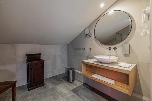 a bathroom with a sink and a mirror at Bohém Borklub in Tállya