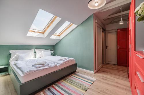 a bedroom with a bed in a room with skylights at Bohém Borklub in Tállya